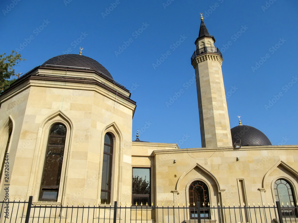 Kiev, Ukraine - October 8, 2018: Dome building and the minaret of the Ar-Rahma mosque in Kiev. Beautiful facade of a Muslim temple of beige stone with crescents on the roofs