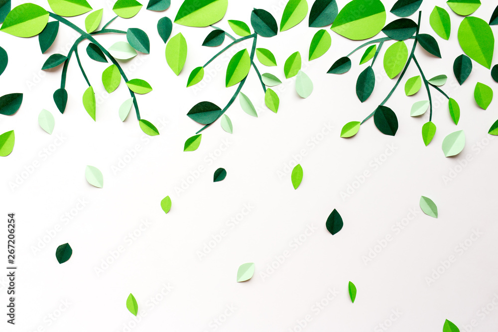 White background with falling green leaves and branches of paper handmade White background with falling green leaves and branches of paper handmade