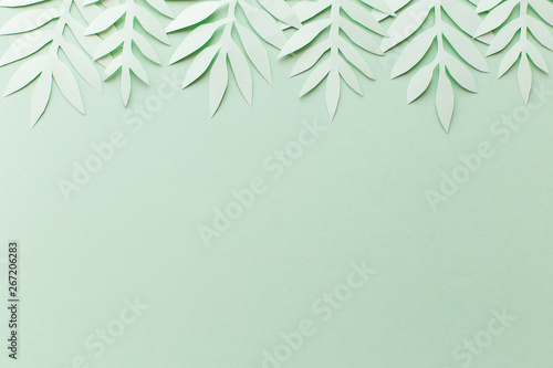 Green background with green leaves of paper, top view, decor for postcard, handmade © Elena