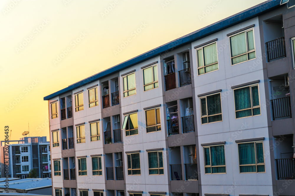 Naklejka premium Condominium block city building sunset sky