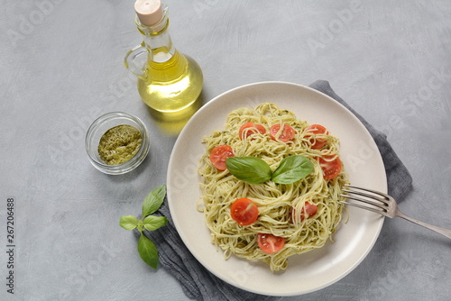 Pasta spaghetti with pesto sauce, fresh basil and cherry tomatoes . Italian traditional food
