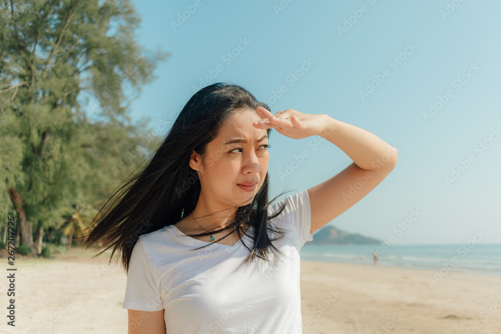 Woman walking along the beach under the sunny day of summer. Woman walking along the beach under the sunny day of summer.