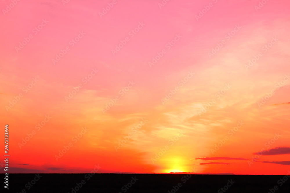 Photo of beautiful bright red color-rich tropical sunset in summer in nice slightly cloudy weather with space for writing advertising text or advertising slogan for travel agency or tour operator