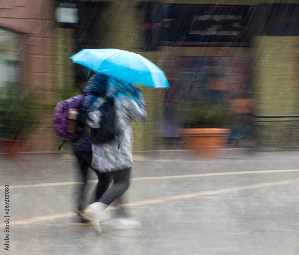 People with umbrella walking down the street on rainy day