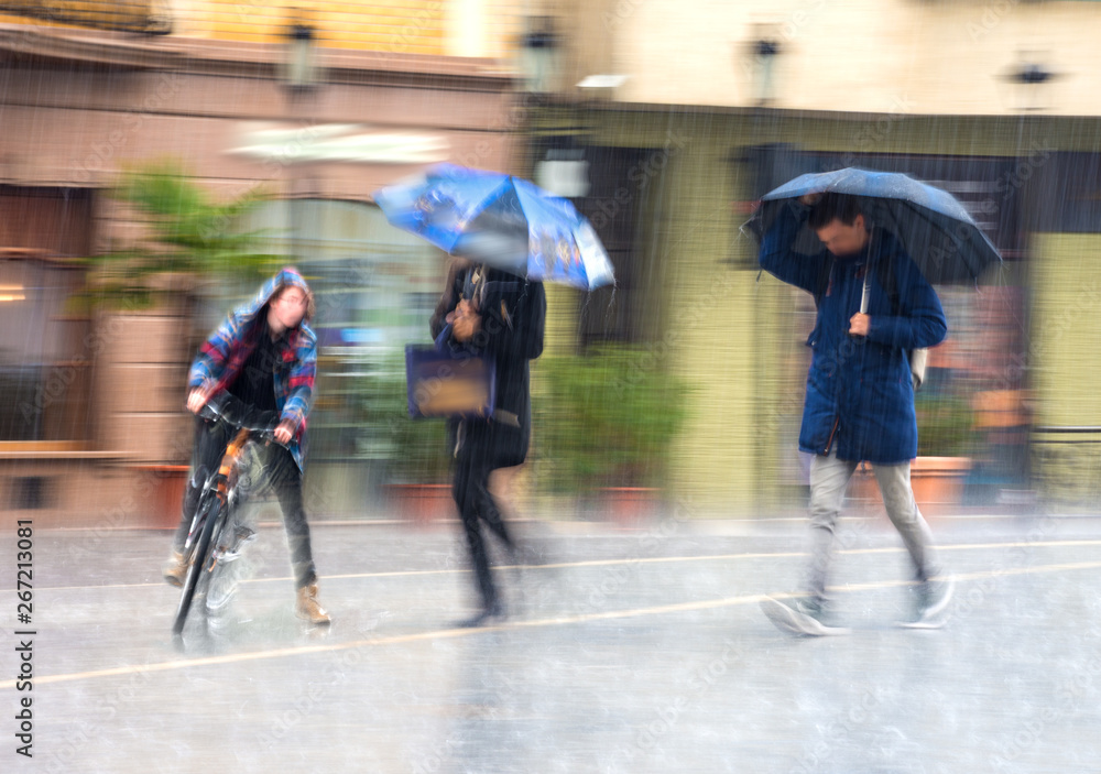 People with umbrella walking down the street on rainy day People with umbrella walking down the street on rainy day
