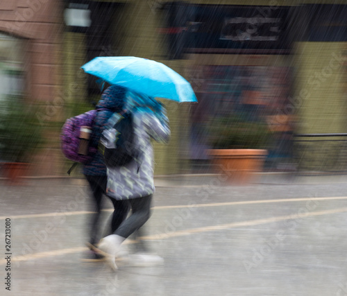 People with umbrella walking down the street on rainy day