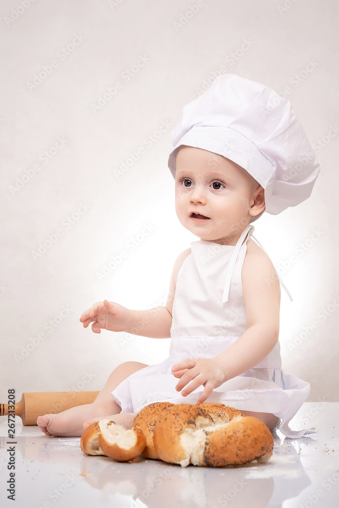 Small child cooks a croissant with bread. laughing happily Small child cooks a croissant with bread. laughing happily
