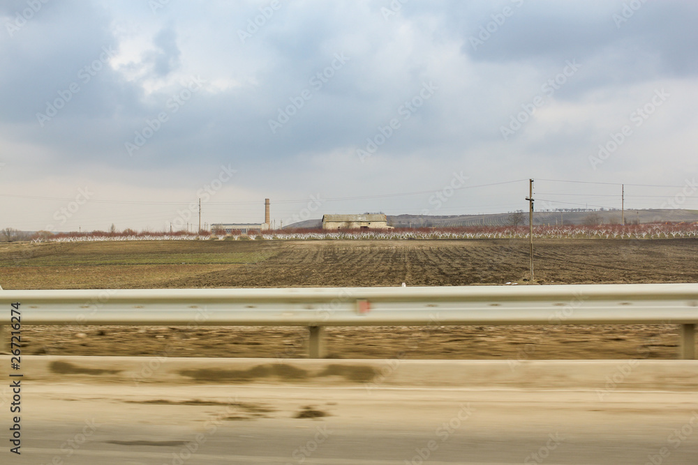 Fields and gardens along the road.