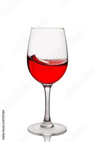Red wine in a glass isolated on white background. Side view.