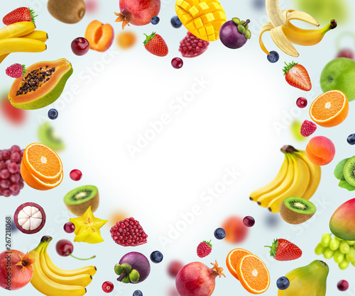 Heart shape frame made of different fruits and berries  isolated on white background  healthy food concept