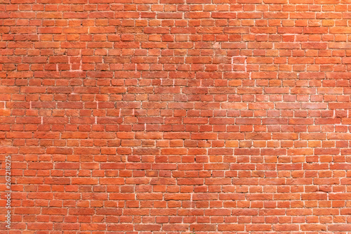 Texture of a red brick wall as a background or wallpaper