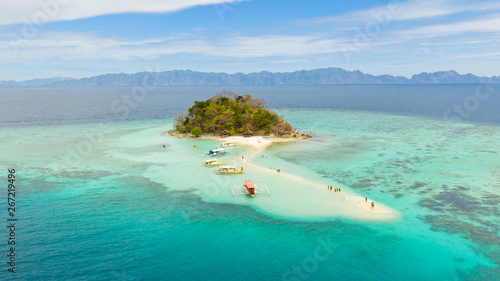 Tropical island Bulog Dos. Tourists walking along the sand bar Seascape in the tropics aerial view.Philippines, Palawan