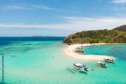 Aerial view tropical beach on island Ditaytayan. tropical island with white sand bar, palm trees and green hills. Travel tropical concept. Palawan, Philippines