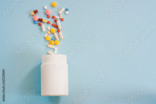 Wallpaper Mural Pill bottle on blue background for use in presentations, education manuals, design. Torontodigital.ca