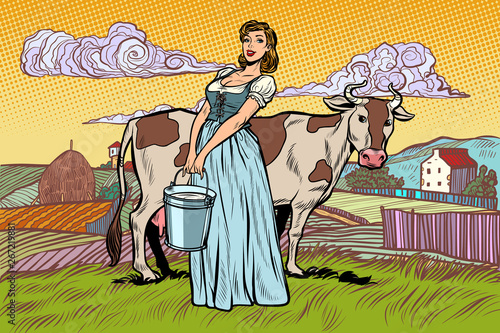 village woman with a bucket of cow milk. farm landscape photo
