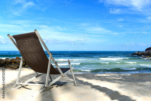 Chair place on tropical beach for background.