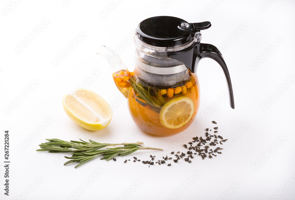 Glass transparent teapot on white backgrounf with tea ingredients Glass transparent teapot on white backgrounf with tea ingredients