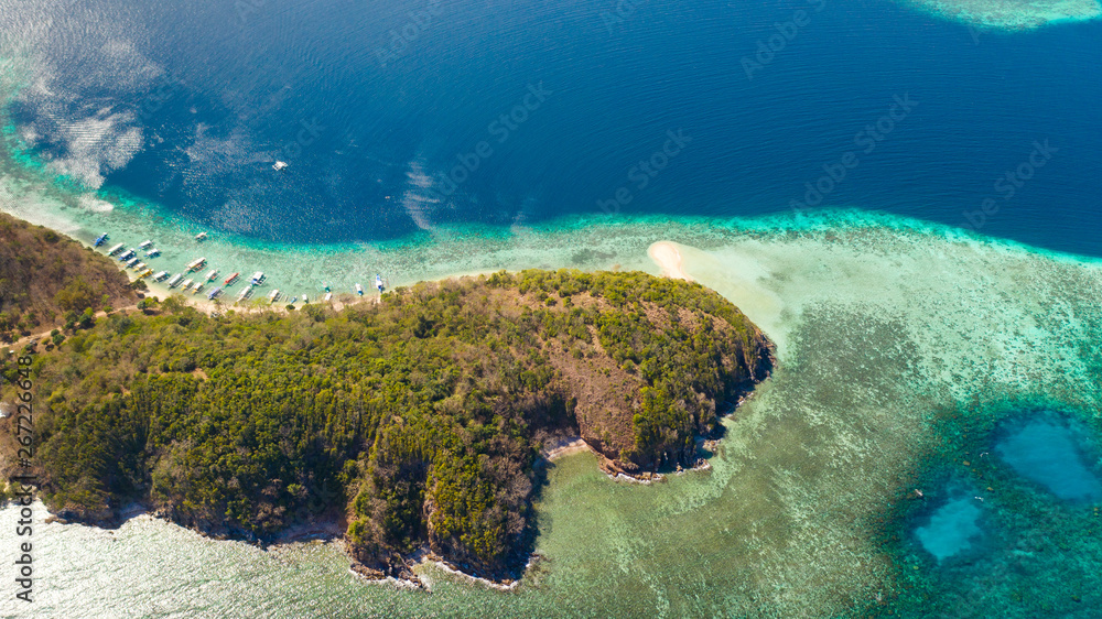 Tropical island with coral reefs. Seascape in the Philippines aerial view