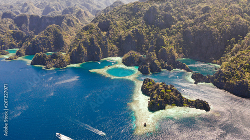 Twin Lagoon in Coron, Palawan, Philippines. Mountain and Sea. Lonely Boat aerial view