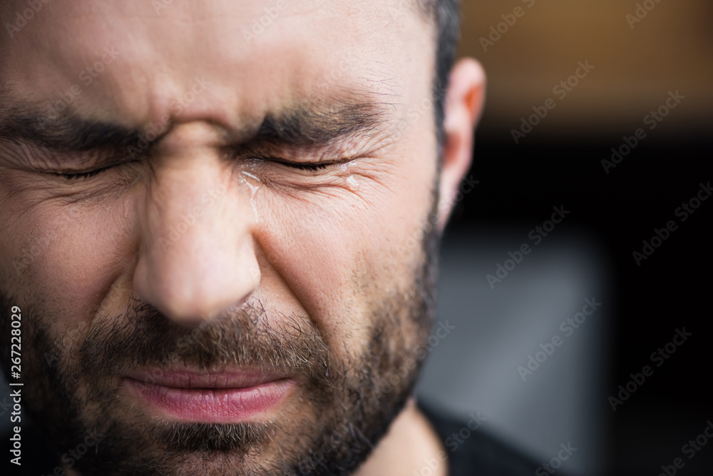 portrait of handsome bearded man crying with closed eyes with tears on face portrait of handsome bearded man crying with closed eyes with tears on face