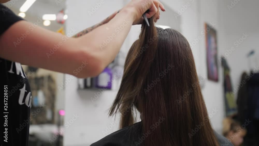 Professional woman hairdresser making creative hairstyle to girl in beauty salon. Professional woman hairdresser making creative hairstyle to girl in beauty salon.