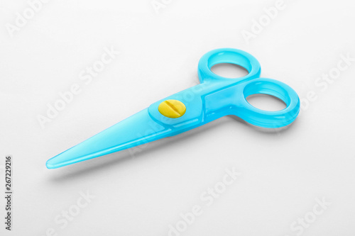 Colorful plastic scissors on white background. School stationery