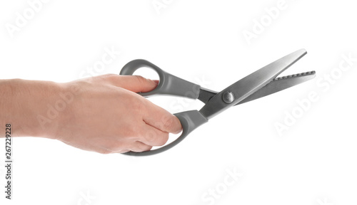 Woman holding sewing scissors on white background, closeup