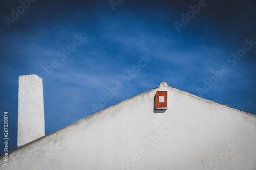 Old small houses with grass and blue sky