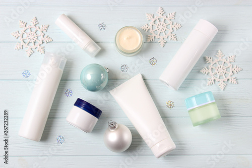 Winter care cosmetics on a colored background top view.