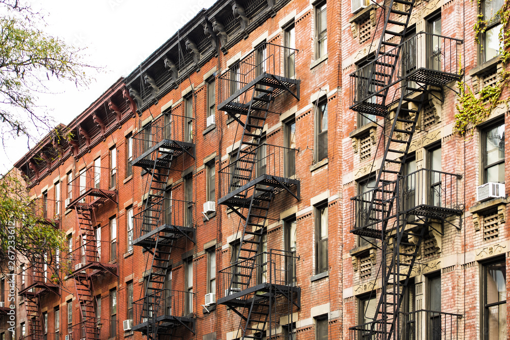 Close-up view of New York City style apartment buildings with emergency stairs along Mott Street in Chinatown neighborhood of Manhattan, New York, United States.