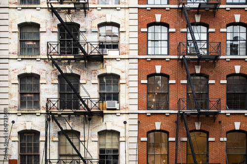 Close-up view of New York City style apartment buildings with emergency stairs along Mott Street in Chinatown neighborhood of Manhattan, New York, United States.
