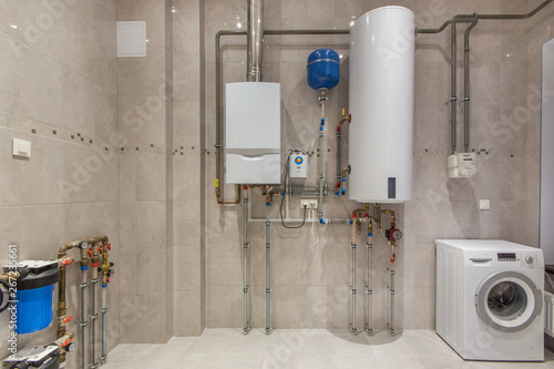Schilderij op canvas Wall hung gas boiler and electric water heater in boiler room