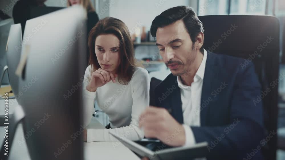 Colleagues are looking for a business solution during work process at sunny office.Business people meeting concept.Blurred background Colleagues are looking for a business solution during work process at sunny office.Business people meeting concept.Blurred background
