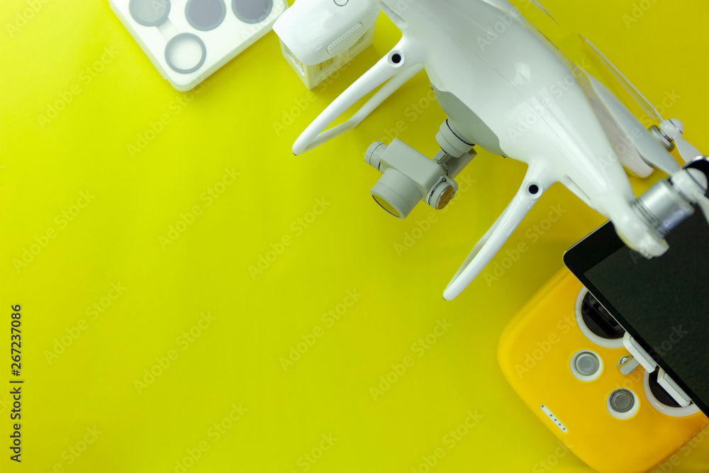 Drone equipment with Remote control on yellow paper background, copy space for your text Top view image, flat lay composition Drone equipment with Remote control on yellow paper background, copy space for your text Top view image, flat lay composition