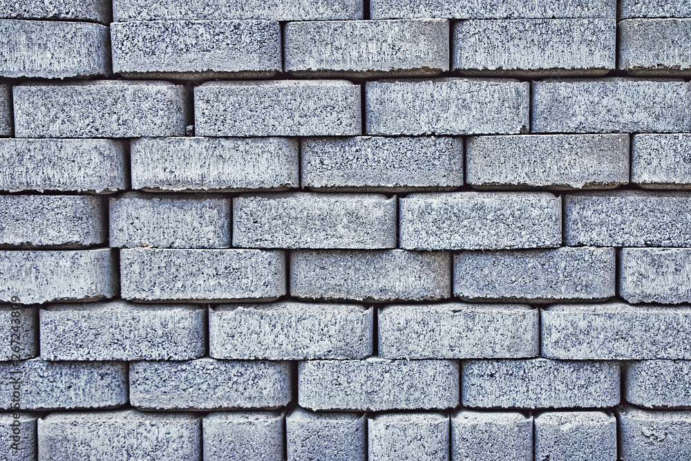 Fototapeta premium Fragment of a gray textured paving tile laying in long parallel lines as a background close-up.