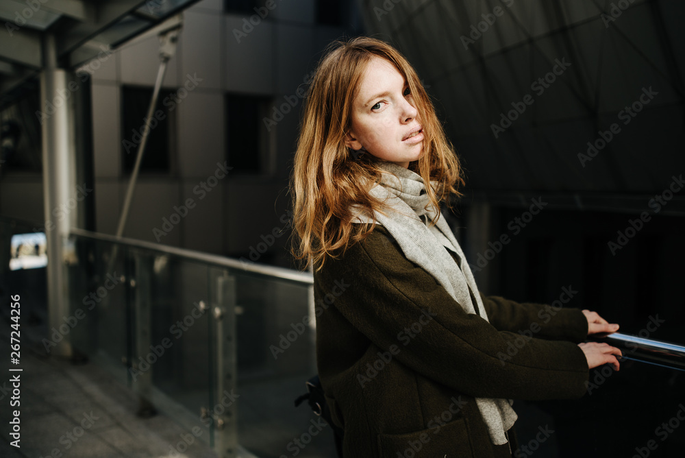beautiful girl in coat with scarf walks on city street, portrait of woman resting outdoors beautiful girl in coat with scarf walks on city street, portrait of woman resting outdoors