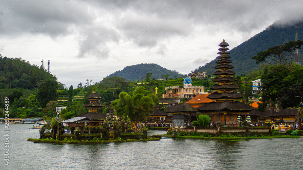 Moody scenic landscape view of Pura Ulun Danu Bratan, Hindu water temple on Bratan lake, tourist most popular attraction in Bali island, Indonesia. Moody scenic landscape view of Pura Ulun Danu Bratan, Hindu water temple on Bratan lake, tourist most popular attraction in Bali island, Indonesia.