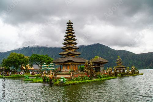 Moody scenic landscape view of Pura Ulun Danu Bratan, Hindu water temple on Bratan lake, tourist most popular attraction in Bali island, Indonesia.