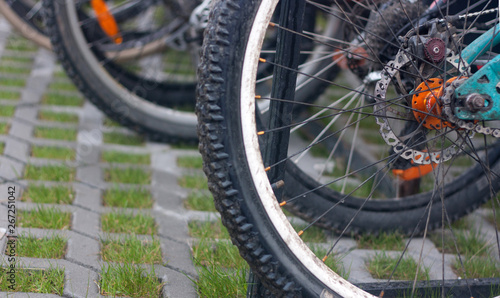 Street bike parking lot. Bicycles tires close up.