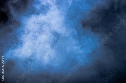 Blue smoke and dense fog on black background. 