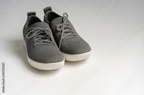 Gray fashion sports shoes on isolated white background.