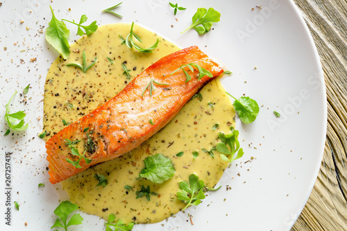 fried salmon with fresh garden cress, thyme, rosemary and dry spices in lemon-mustard sauce 