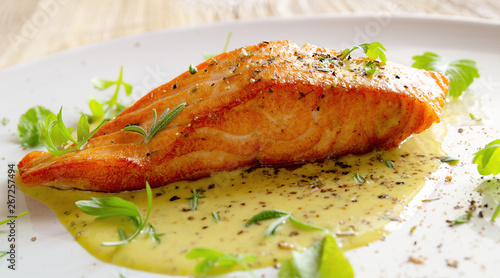 fried salmon fillet with fresh herbs and spices in lemon-mustard sauce