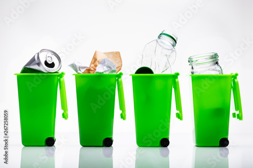 Green Recycle Bins With Used Bottle And Tin Can