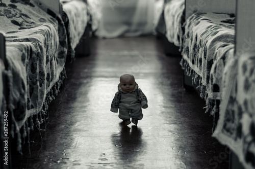 Little scary doll walks between the beds
