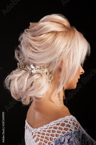 Portrait of woman with blonde hair and elegant coiffure in studio