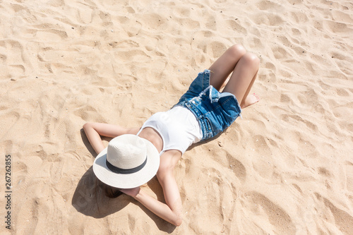 A woman is laying on the Beach