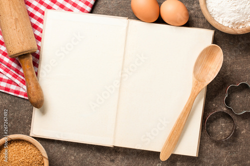 Baking concept with cookbook and ingredients photo