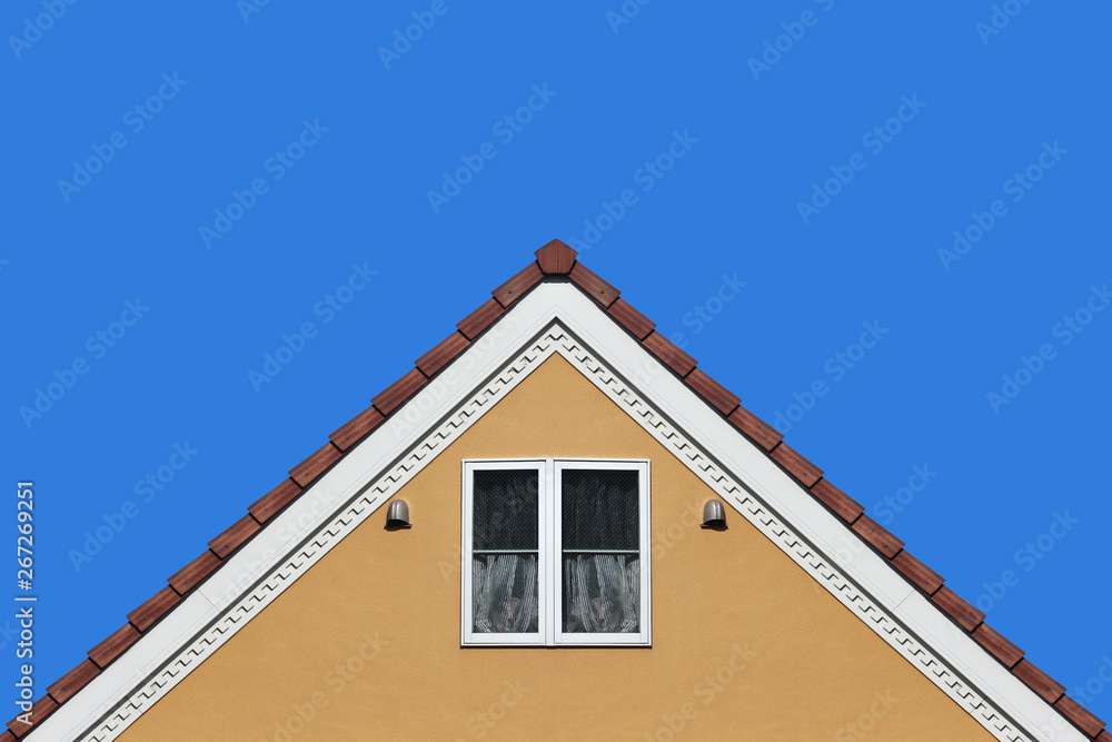 modern orange house gable roof design wall with clear blue sky background.