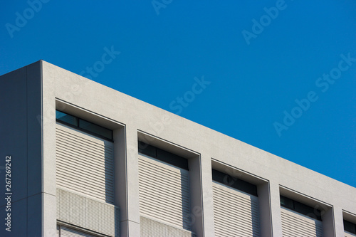 High building part with blue sky background.